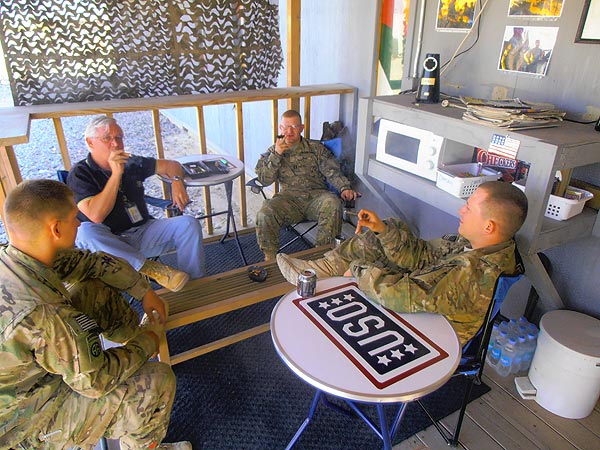 John H. Prieth (2nd from left) on the Chapel porch with the Brigade Chaplin (3rd from left) and other members of the 82nd Airborne Division. "We are participating in the regularly scheduled informal Chaplin&rsquo;s Cigar Fellowship and &rsquo;Open Air Confessional.&rsquo;"