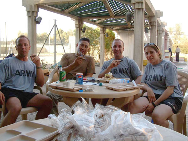 CW2 Johnny Moncada (brown shirt), sitting with Matt, Mike and Tara inMosul, Iraq enjoying Romeo y Julieta cigars. They are Warrant officers inthe U.S. Army supporting the 101st Airborne Division (Air Assault).
