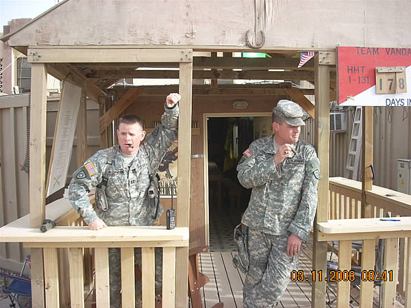 Team Vandal, 1st Squadron, 131st Cavalry Regiment&rsquo;s CPT Brett Williamson, and CPT David Van Horn, take a moment to savor a Gurkha Centurion and Gurkha Expedition, respectively, in front of their Combat Operations Center at COB Speicher.