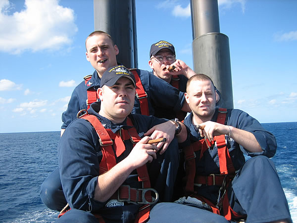 (Clock-wise, top left) ET2(SS) Paul Evans, HMC(SS/FMF) Paul Schiowitz, ET2(SS) Jeremy Easterday and CS1(SS) Mark Shipley in the sail of the USS Philadelphia (SSN-690) deployed in the Persian Gulf.  HMC Schiowitz was just awarded his Submarine Service Warfare pin (his fish) while on the surface.