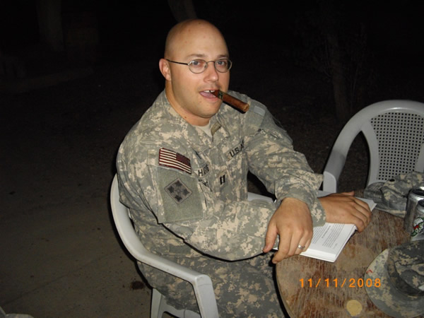 An Army chaplain enjoying a cigar at the Mudhouse