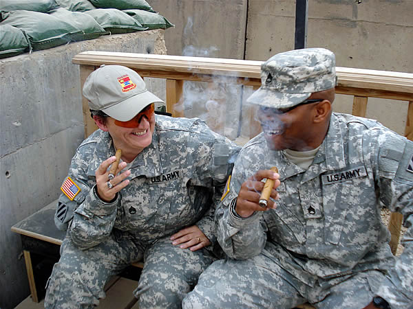 SSG Pehrson and SSG Spencer of 703rd BSB enjoying a laugh and a cigar on FOB KALSU. IRAQ.
