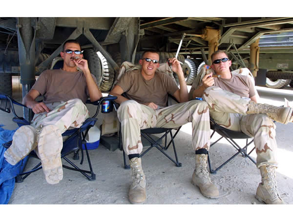 SSG Rich Howell, 1LT Shawn Muder, and 2LT Sean Passmore enjoying some fine cigars while serving in support of Operation Iraqi Freedom.