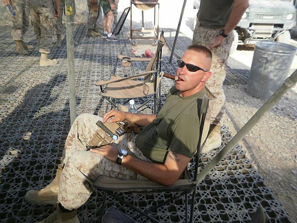 Gunny Granger relaxing with a cigar in Afghanistan.