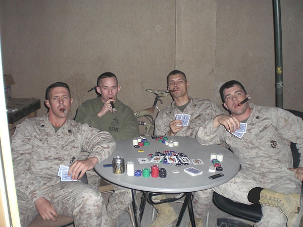Right to left: Sergeant Ronald Graham, Corporal Desty Dixson,Staff Sergeant Christopher Blubaugh, and Staff Sergeant Chet Smith, playing a little poker and smoking some cigars.