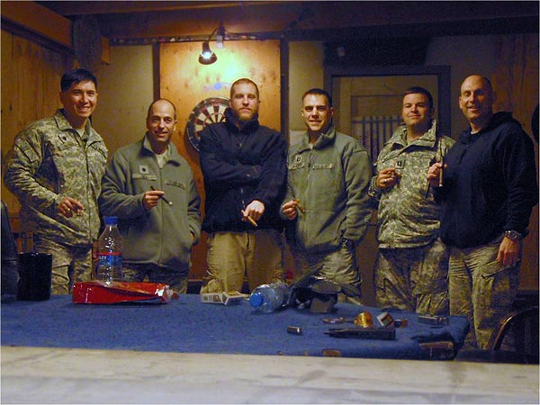 "The attached photos are from an airfield in Afghanistan. Our cigar club &rsquo;meets&rsquo; every Saturday night on the rooftop of our building for smokes and watching the fighter jets streak down the flight line and off into the night&rsquo;s sky. ...We have a little more than a month left and the cigar club has been one liberty that has helped the time move right along!"-Daniel Geisler