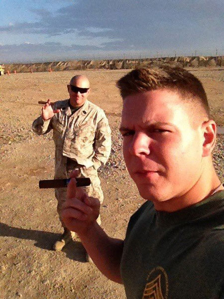 "Master Gunnery Sergeant and Corporal Colombo share a father and son moment while each enjoys an ACID Kuba Kuba under the Afghan afternoon sun. Thank you CI for your patriotism and support!"