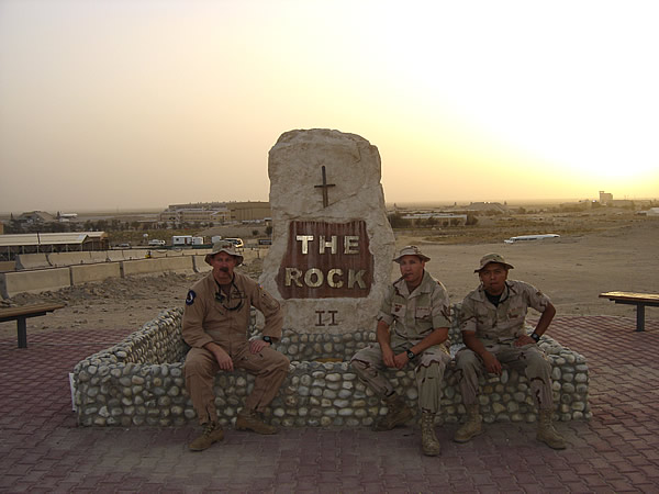 Three soldiers enjoying a cigar at sunset while deployed to Ali Al Salem airbase in Kuwait.