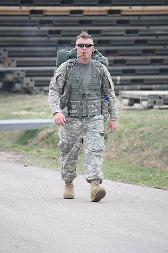 A soldier during the final 100m of the DANCON March. The DANCON (Danish Contingent) march is a 26km (16 mi) marched that must be done in less than eight hours with a 10kg (22 lbs) load. The cigar is a CI Legend, Copper Label.