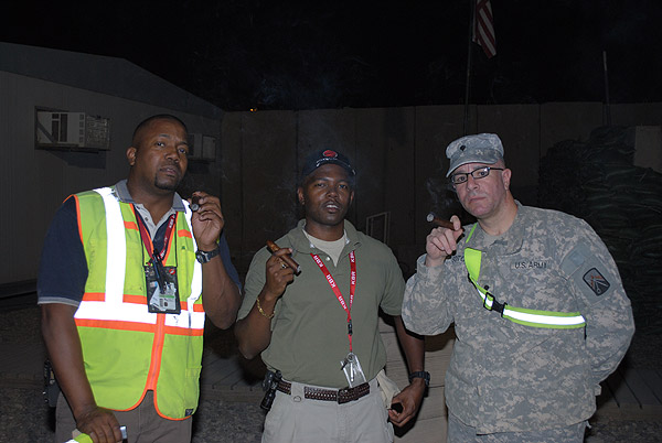 Mark Randal and SPC Soto are enjoying some fine cigars from CI in Iraq. "Thanks CI."