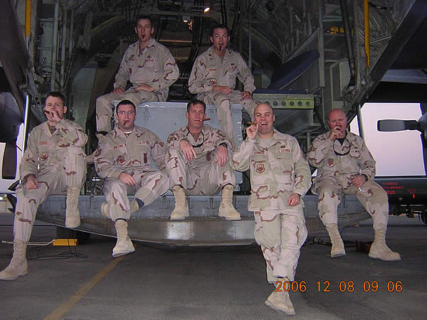 Members of the 386 Expeditionary Civil Engineering Squadron sitting in the back of a C-130 enjoying their cigars.