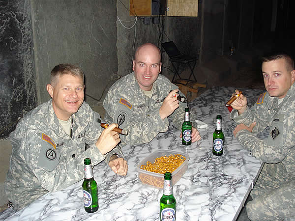 LTC Greg McMahan(L) and CPT Dave Storch(R), US Army Corps of Engineers, enjoy Indian Tabac Corojos with MAJ Drew Horavath, Camp Mayor, after a cookout at FOB Kalsu, Iraq. on 14 NOV 2007.