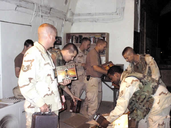 (M) Sgt. Patrick Van Vranken, handing out cigars to troops at a ammo base in Balad, Iraq.