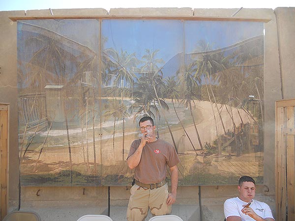 CE2 Vivian smoking a cigar on the &rsquo;beach&rsquo;. "I&rsquo;m an Electrician with a Navy SeaBee detachment in Iraq and I&rsquo;m proud to say I&rsquo;ve gotten several of my fellow bees on the cigar train."