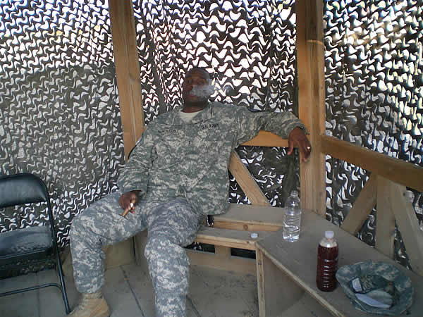 CW2 McNorton enjoying a cigar and relaxing in the smoking area at Camp Liberty, Iraq 24 Aug 07.