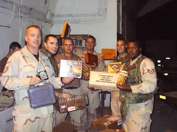 (M) Sgt. Patrick Van Vranken, handing out cigars to troops at a ammo base in Balad, Iraq.