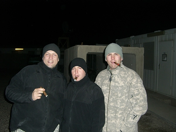 From left to right: CPT Lynn, 1LT Stockton and CPT Woodward enjoying cigars on Super Bowl night while stationed in Iraq.