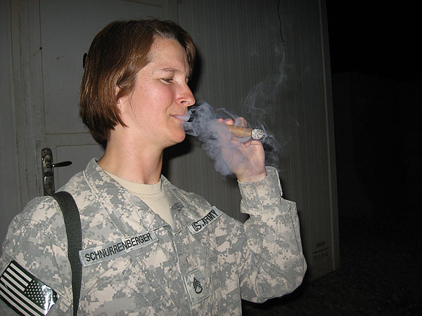 SSG Schnurrenberger, Jody L. of 883rd Combat Stress Control enjoys her first ever tobacco product in Iraq with medics PFC Pemberton, Brandon and SPC Pugsley, Michael (neither pictured), both of Lion Battery 2/3 Armored Cavalry Regiment. "Thanks guys and thanks Cigars International! What an experience that was!"
