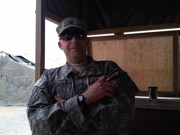 A soldier smoking a Man O&rsquo; War."Here is me enjoying my favorite past time in Kuwait, smoking cigars from C.I.!"