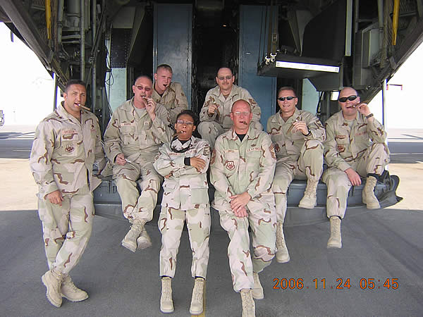 Members of the 386 Expeditionary Civil Engineering Squadron sitting in the back of a C-130 enjoying their cigars.