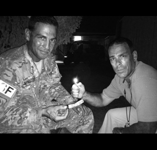 TSgt Mahaffey having a long ash contest in East Africa smoking a Gurkha Status Maduro Torpedo. "I will always buy my cigars from you especially the Gurkha."