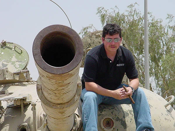 Tracy Coultas, a retired Air Force Senior NCO, now working for Dimensions International as an Army Contractor in the Army Field Support Brigade-Iraq, sits on one of the last Iraqi tanks at Camp Anaconda, Balad, Iraq.