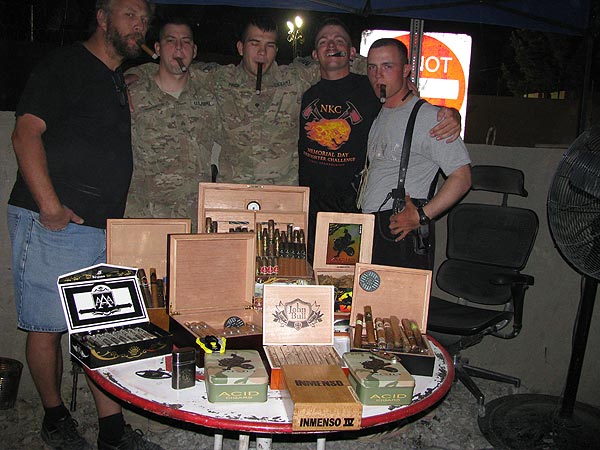 The USFOR-A / NKC 1165th Military Police, stationed in Afghanistan. "Here are some pictures of my fellow Soldiers, friends, and myself enjoying the wonderful cigars that you sell."