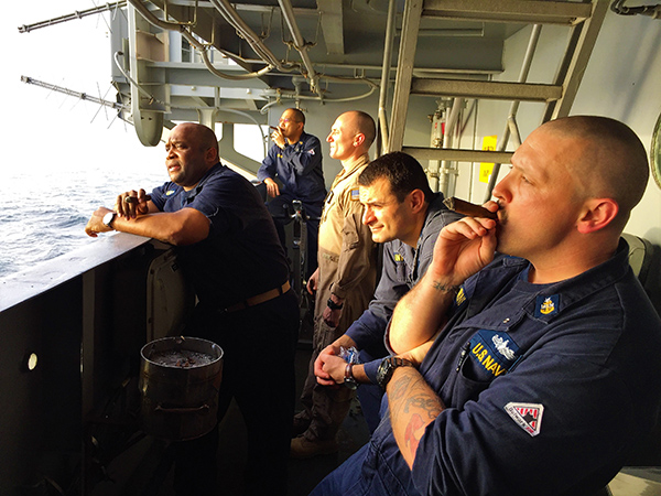 Members of the USS Nimitz as part of the (CSG-11) enjoying cigars.