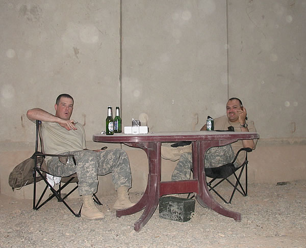 CPT Curt Keppeler and SFC Paul Salinas III enjoying smokes and near-beers at COB Speicher, Iraq.