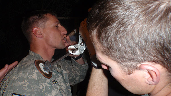 SGT Max is a Flight Medic of C Co 1/189th GSAB MEDEVAC unit currently in Iraq participating in &rsquo;the branding&rsquo; (a new unit tradition) while enjoying an Acid Deep Dish.